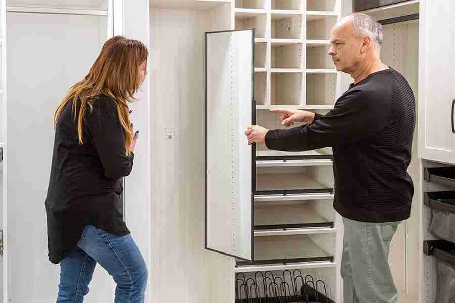 A man and a woman discussing closet design.