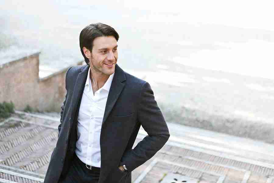 a man in a suit walking up stairs