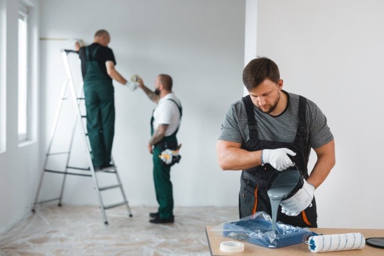 crew of people painting a room