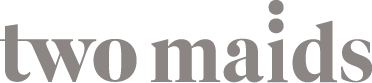 Grey text logo stating Two Maids.